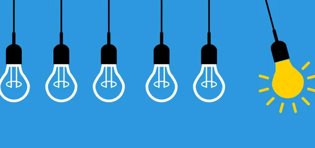 A row of hanging light bulbs, with one glowing yellow bulb standing out among the unlit bulbs against a blue background.
